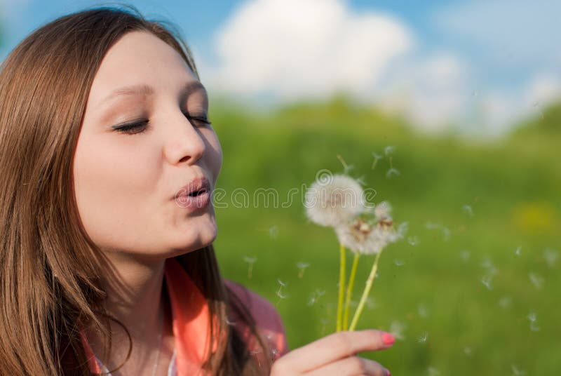 Framed print, beauty girl takes beautiful flowers in her hands blowing