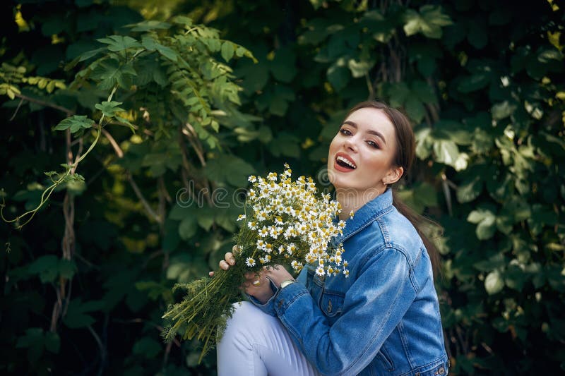 Beautiful Young Woman with a Bouquet of Daisies . Stock Image - Image ...