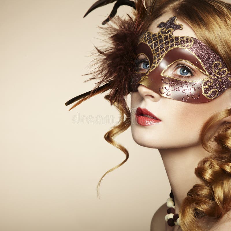 Beautiful young woman in brown venetian mask