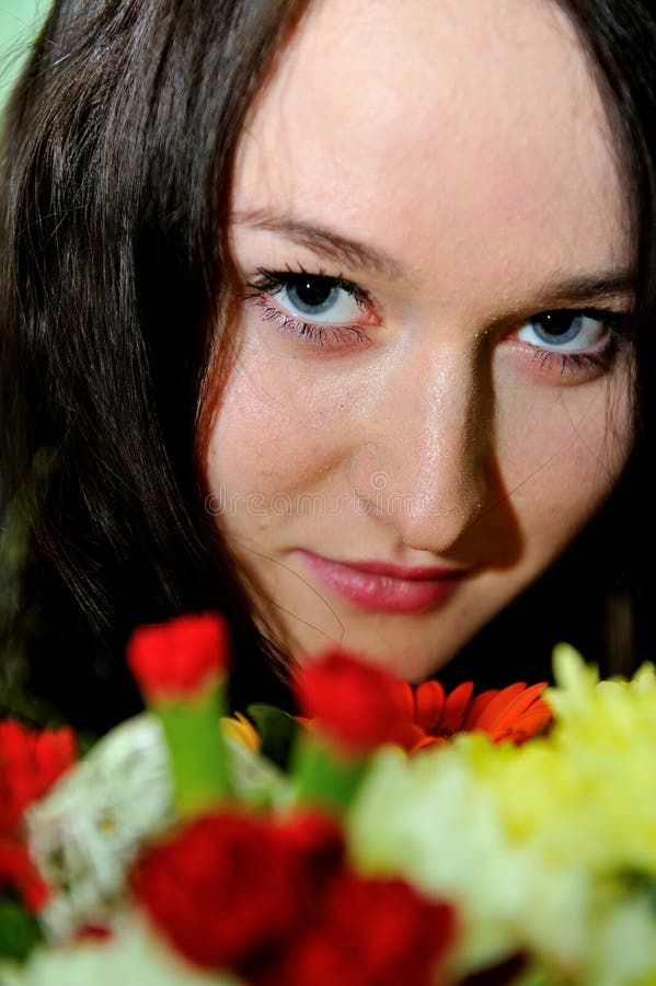 Beautiful young woman with bunch of flowers royalty free stock photo Beautiful young woman with bunch of flowers royalty free stock photo