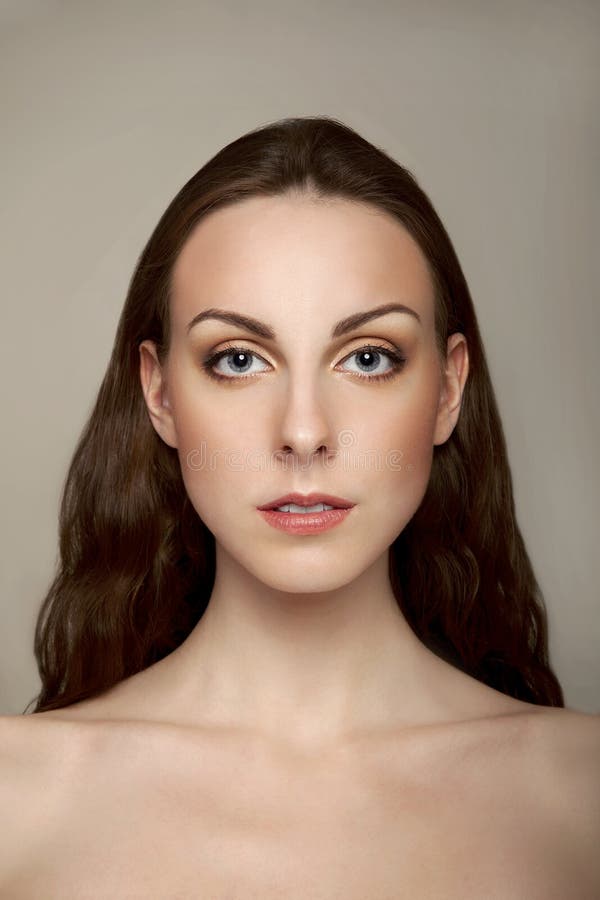 Closeup of a Beautiful Young Woman Smiling on White Background Stock