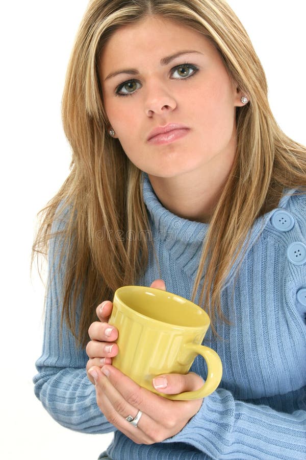 Beautiful teen girl in blue sweater with coffee mug. Shot in studio over whte. Beautiful teen girl in blue sweater with coffee mug. Shot in studio over whte.