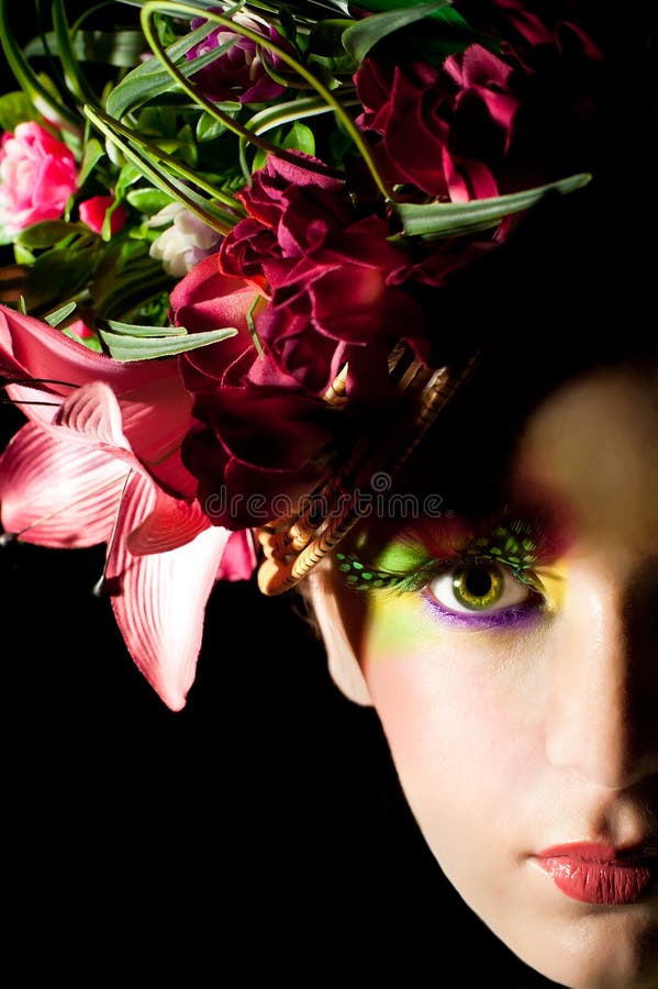 Beautiful young woman with creative flower cap