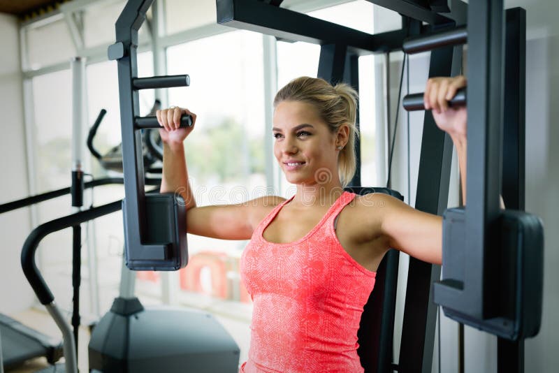 Beautiful young woman doing exercises for chest