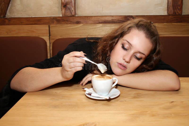 Beautiful young woman drinking coffee