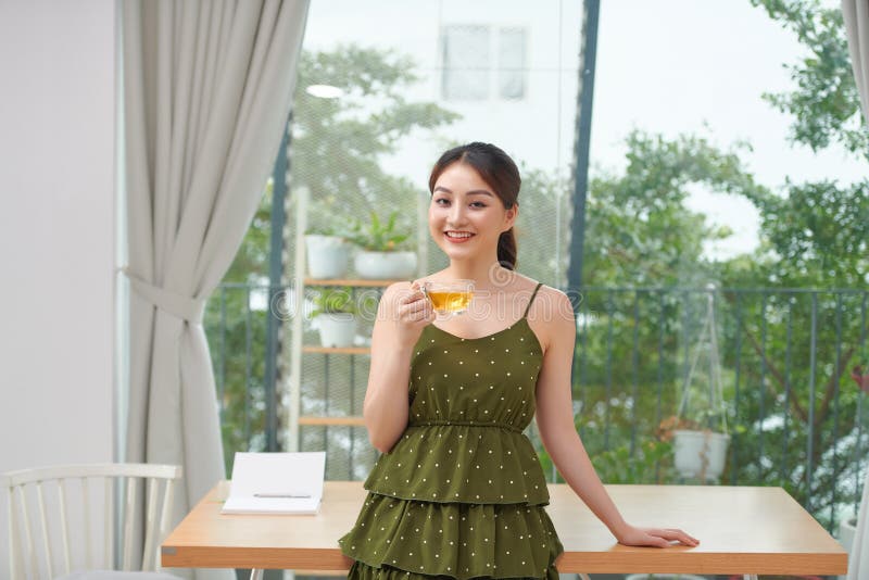 Beautiful young woman drinking tea stock photos