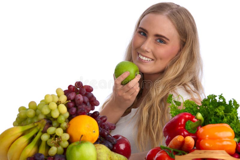 Beautiful young woman eating green apple