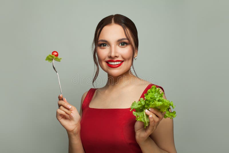 Beautiful young woman eating healthy food. Healthy eating and diet concept