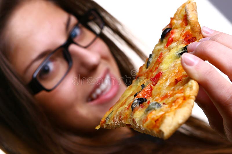 Beautiful young woman eating pizza