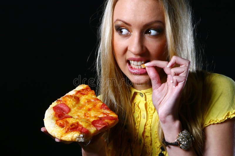 Beautiful young woman eating pizza