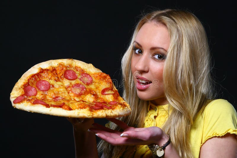 Beautiful young woman eating pizza