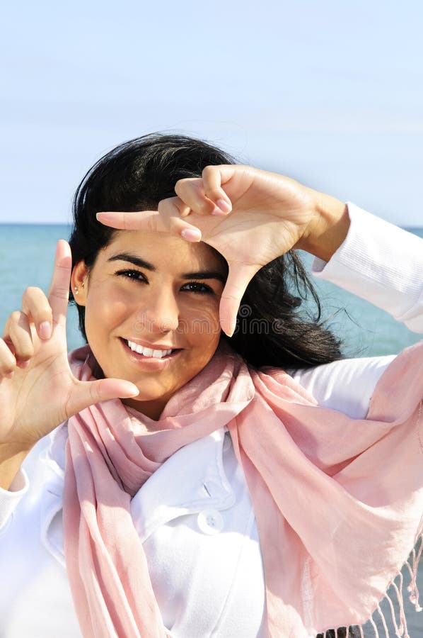 Beautiful young woman framing her face stock images Beautiful young woman framing her face stock images