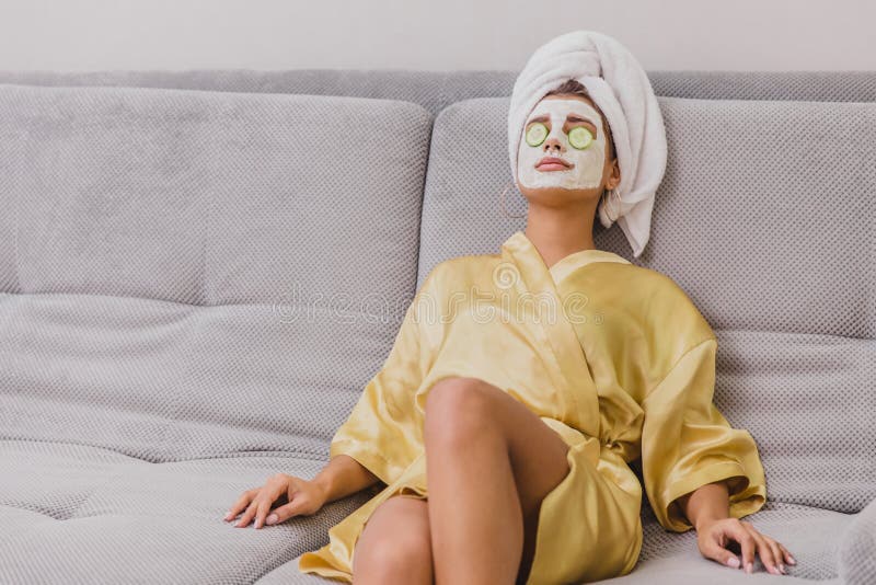 A Beautiful Young Woman Gets A Face Mask In The Spa Center Lying With