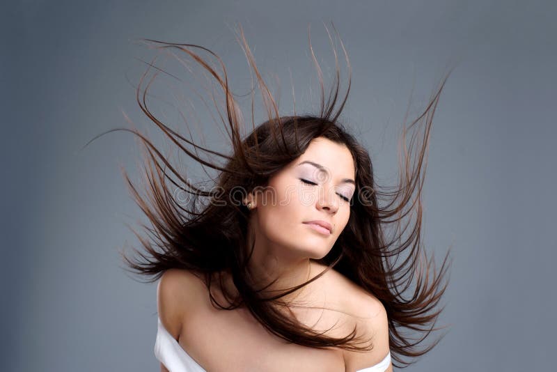 Beautiful young woman with hair flying