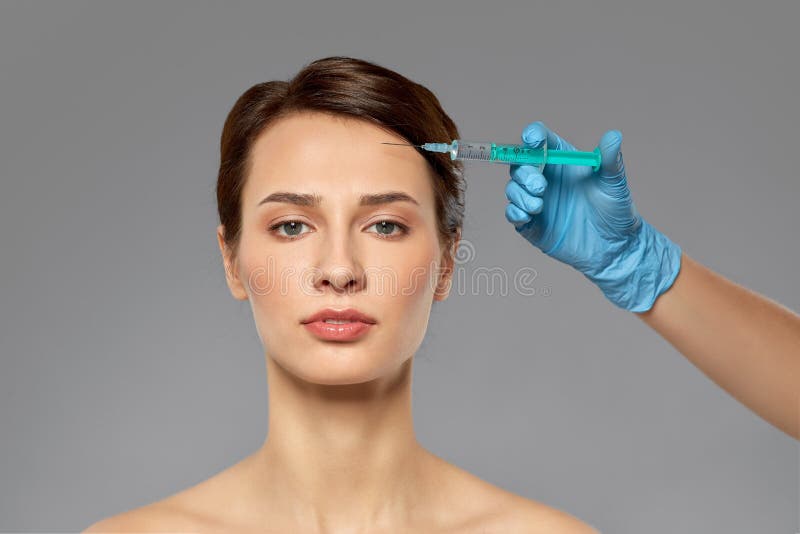 Beautiful young woman and hand with syringe stock images Beautiful young woman and hand with syringe stock images