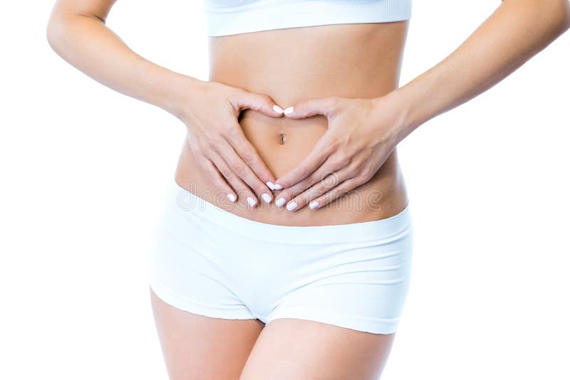 Beautiful young woman with hands on belly-stomach ache over white background.