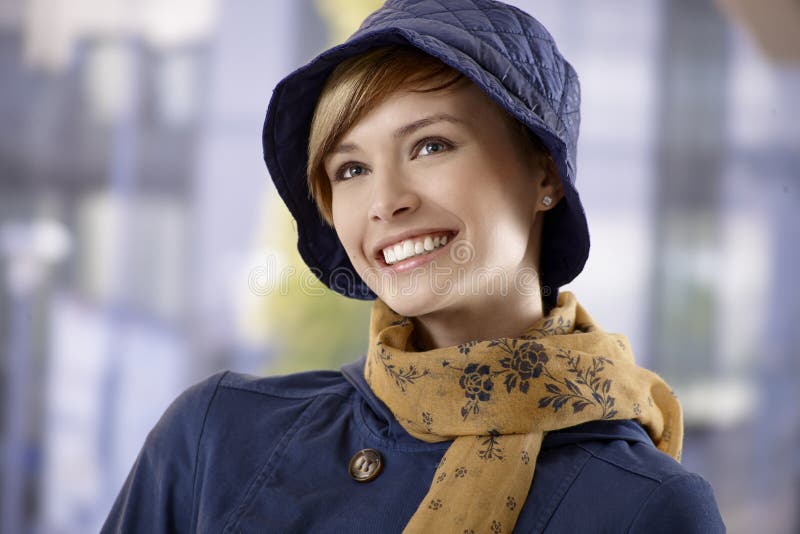 Beautiful young woman in hat and scarf