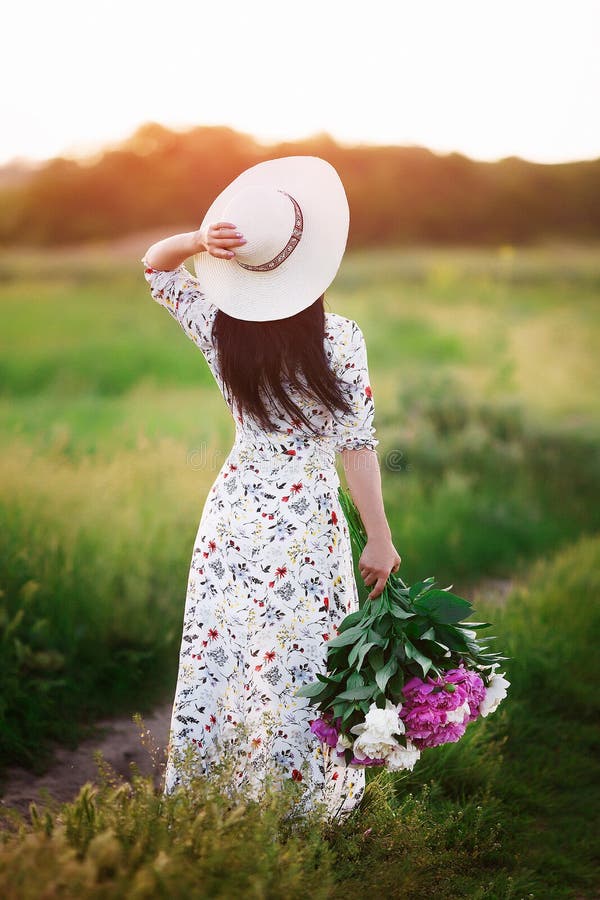 Beautiful Young Woman Holding Bouquet of Flowers while Walking Outdoor ...