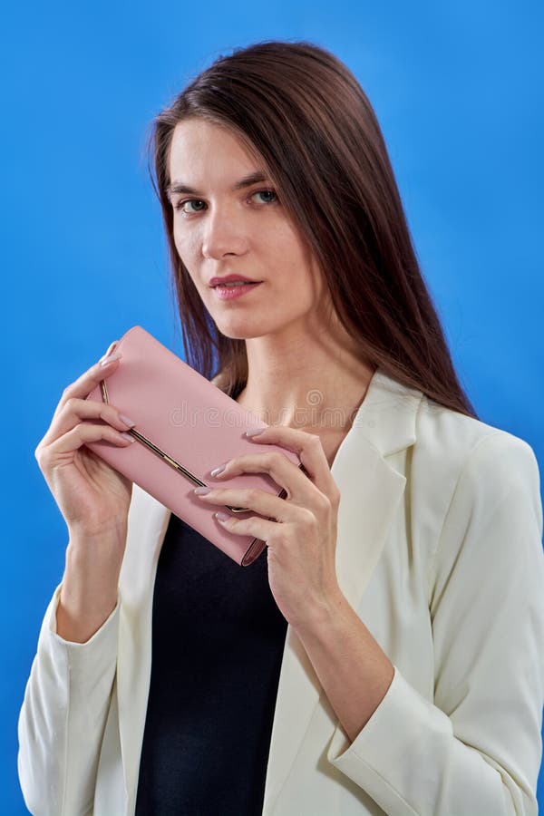 A Beautiful Young Woman is Holding a Pink Purse on a Blue Background ...