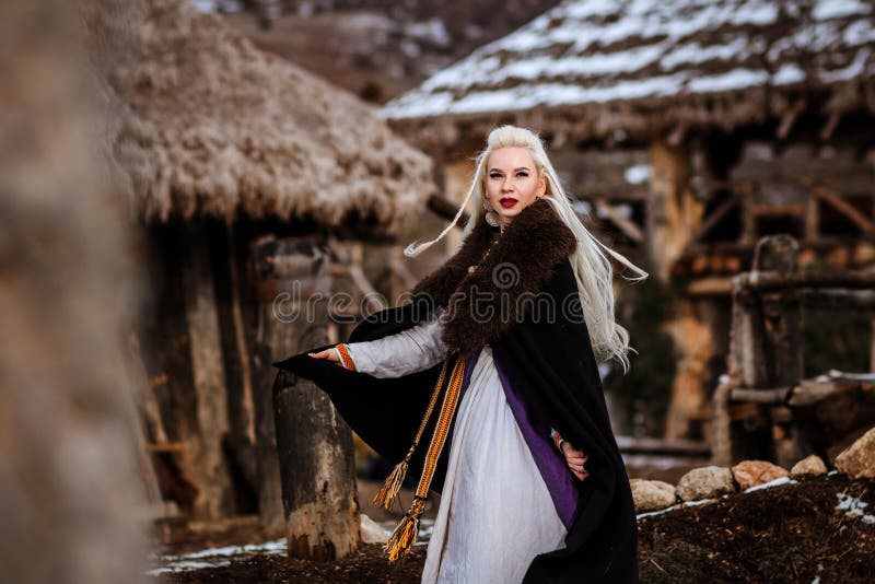 Beautiful Young Woman Holding a Viking with Blond Hair. Image of ...