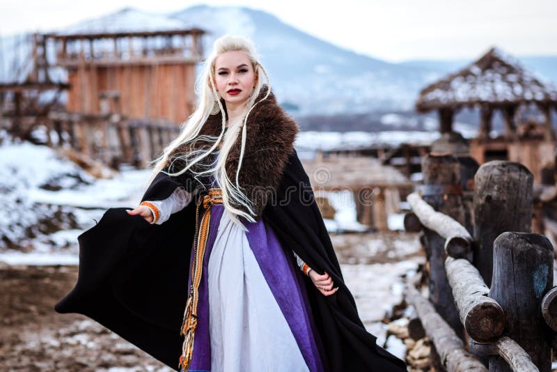 Beautiful Young Woman Holding a Viking with Blond Hair. Image of ...