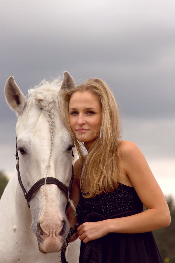 Beautiful young woman with a horse