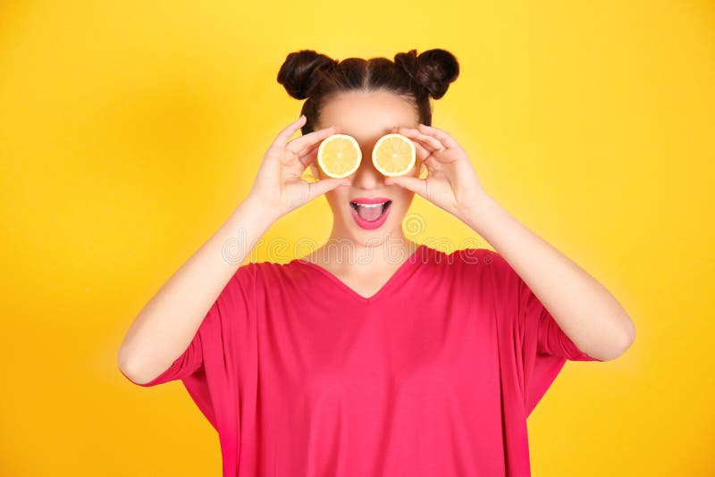 Beautiful young woman with lemon halves near eyes stock photography Beautiful young woman with lemon halves near eyes stock photography