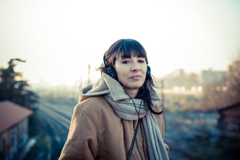 Beautiful young woman listening to music headphones