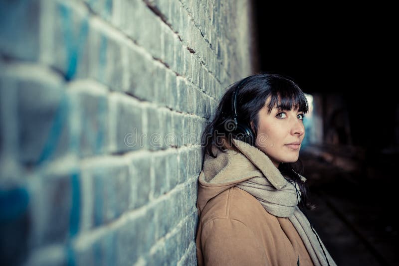 Beautiful young woman listening to music headphones