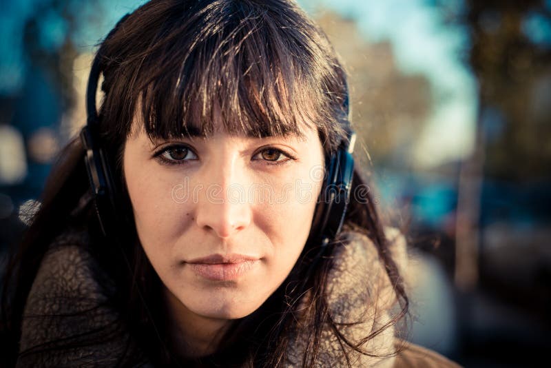 Beautiful young woman listening to music headphones