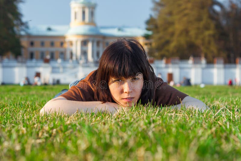 Beautiful Young Woman lying on a field, green grass. Outdoors Enjoy Nature. stock photography Beautiful Young Woman lying on a field, green grass. Outdoors Enjoy Nature. stock photography