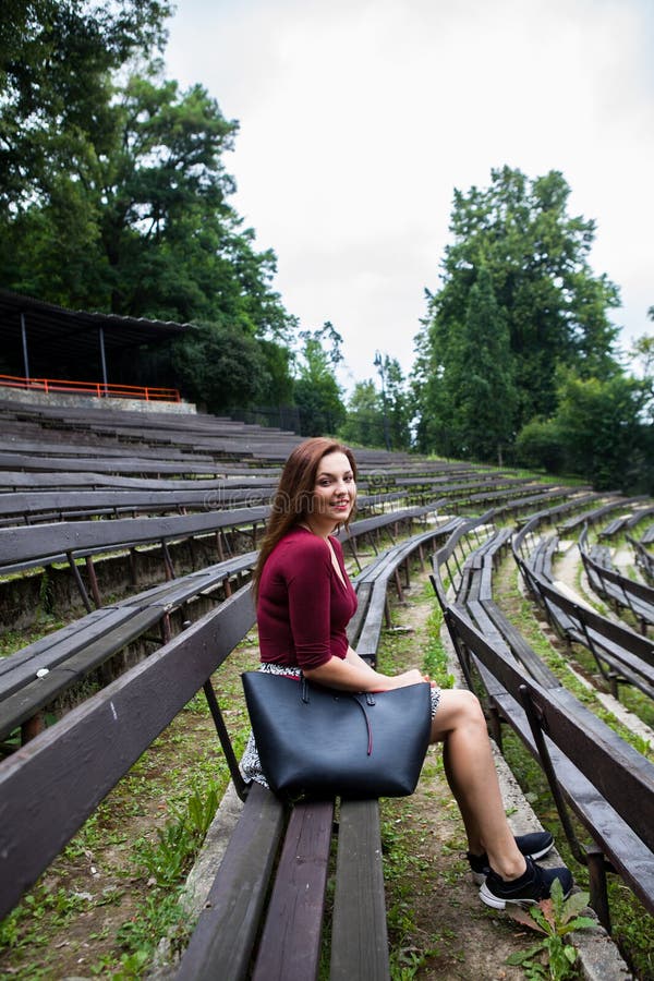 Beautiful young woman in the outdoor theater smiling