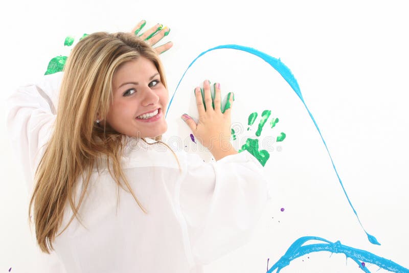 Beautiful Young Woman Painting on Wall