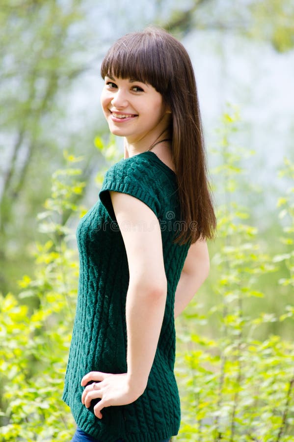 Beautiful young woman in park wearing knitted green blouse stock images Beautiful young woman in park wearing knitted green blouse stock images