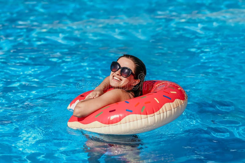 Beautiful young woman with pink donut circle have rest