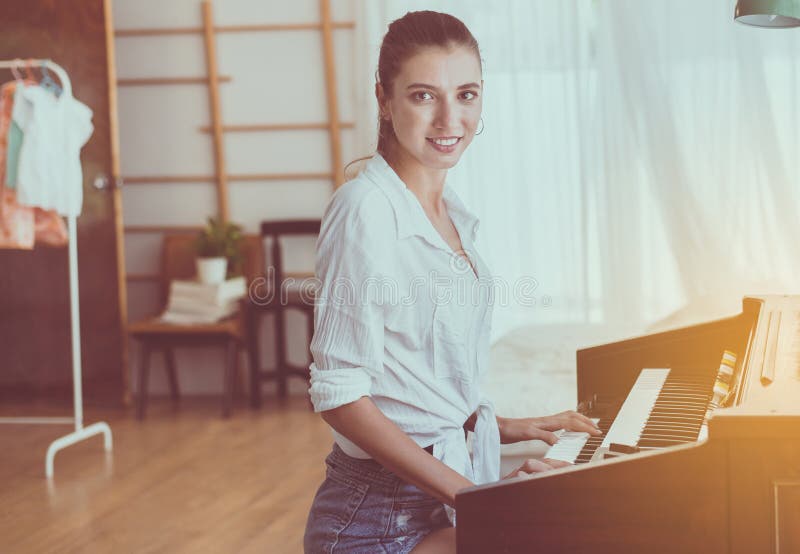 Beautiful young woman playing electronic piano,Happy and smiling,Relaxing time royalty free stock images Beautiful young woman playing electronic piano,Happy and smiling,Relaxing time royalty free stock images