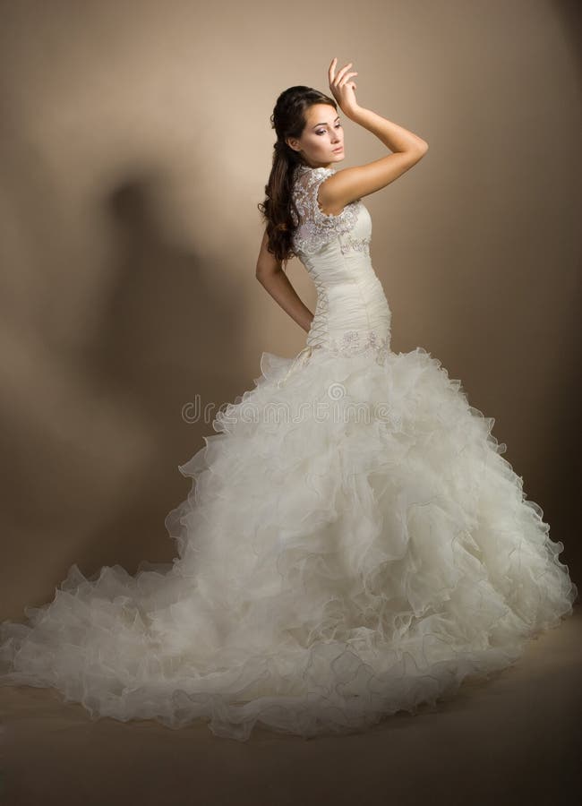 Beautiful young woman posing in a wedding dress