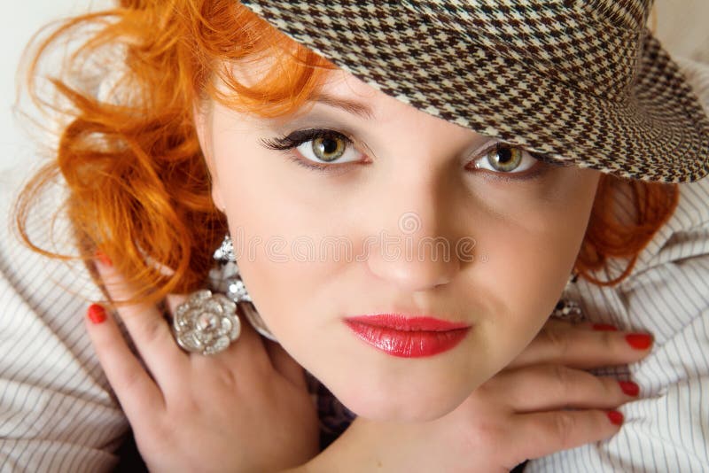 Young woman with red hairs in fedora hat