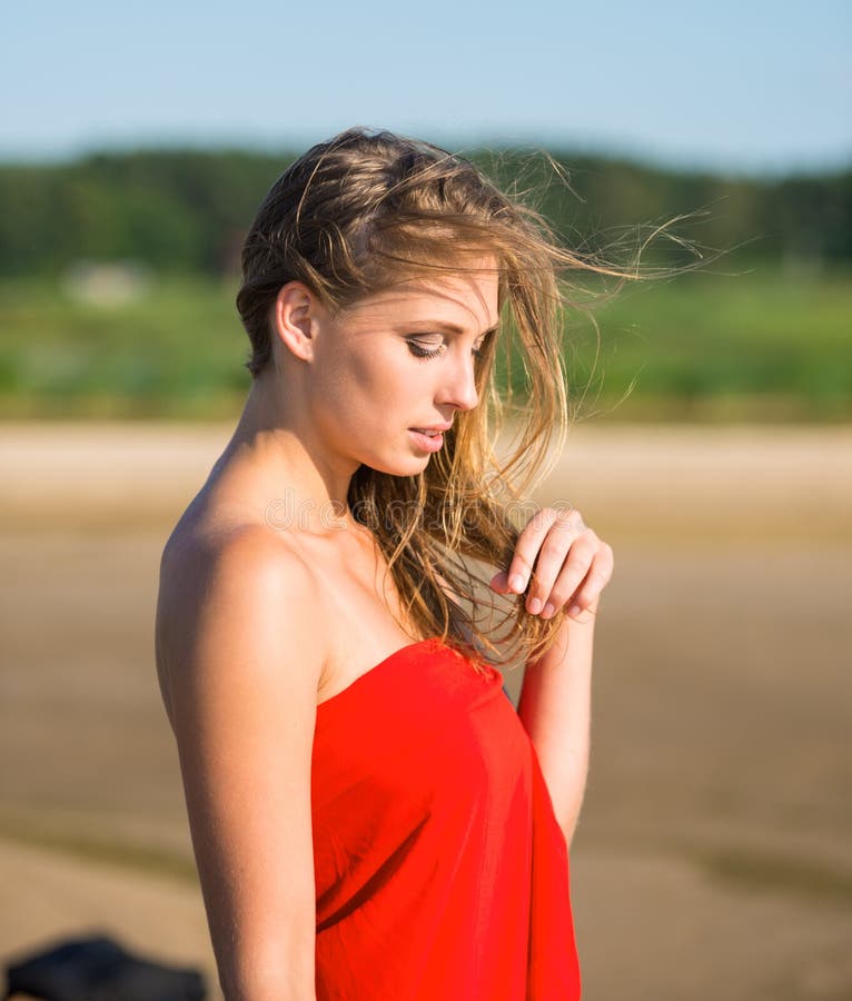 Beautiful young woman in red fabric