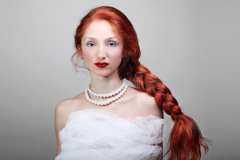 Beautiful young woman with red hair bride