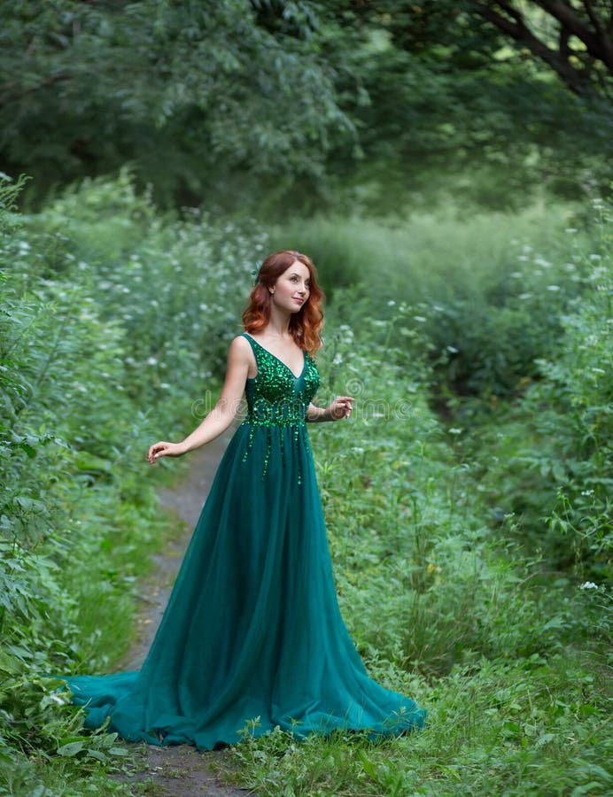 Red Hair Charming Woman is Lying on the Grass in a Wonderful Emerald ...