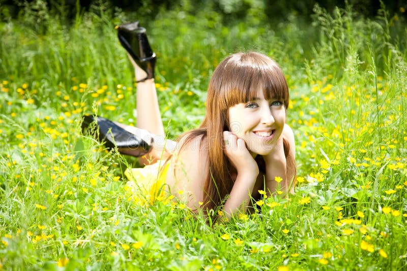 Beautiful young woman relaxing in the grass