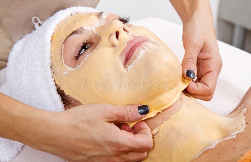 Beautiful young woman remove facial mask in a beauty center