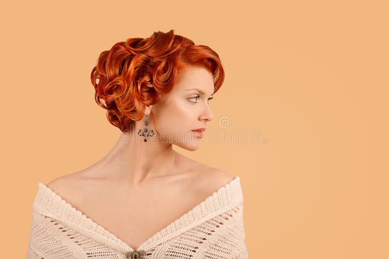 Retro beauty girl curly up hairdo style posing in studio in side profile