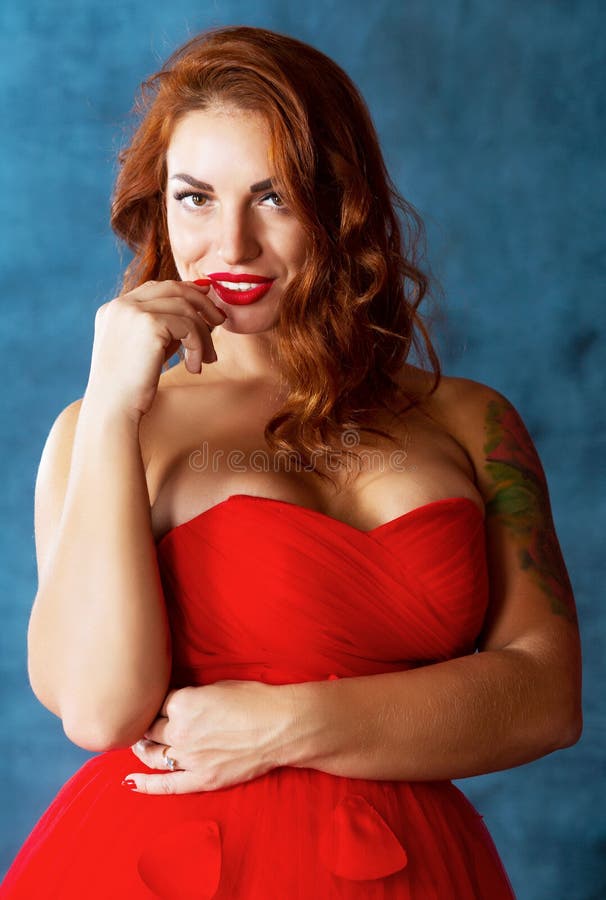 Beautiful young woman wearing a red dress