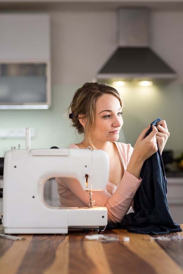 Beautiful young woman sewing clothes with sewing machine royalty free stock images Beautiful young woman sewing clothes with sewing machine royalty free stock images