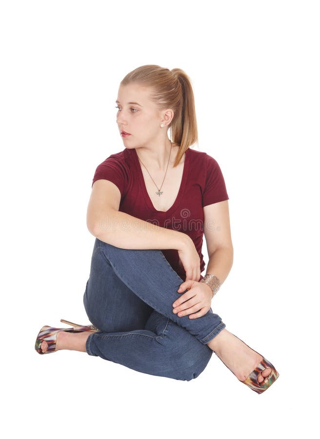 Beautiful young woman sitting on floor