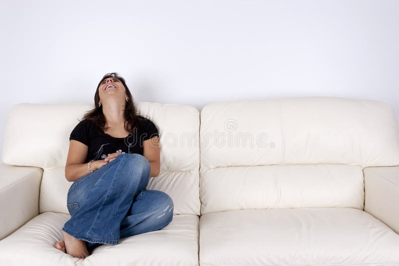 Beautiful young woman sitting in white sofa