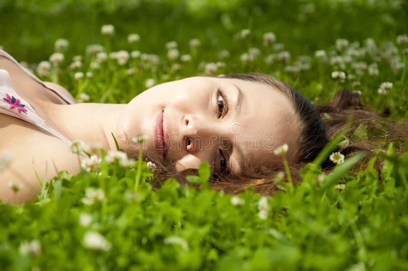 Beautiful young woman smiling on grass field