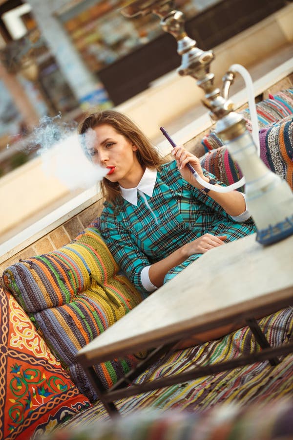 Beautiful Young Woman Smokes a Hookah in a Cafe Stock Image Image of